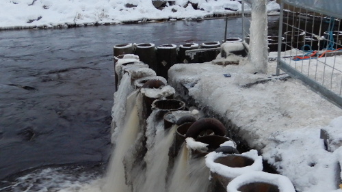 Vattenpumpar pumpar vatten vid en å i Nykarleby.