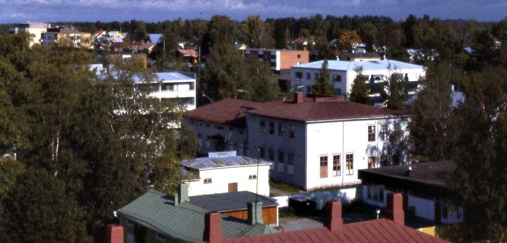Samskolan med dess uthus i mitten, f.d. Föreningsbankens tak i förgrunden. Fotot kan vara taget allt mellan 1975 och 1982.